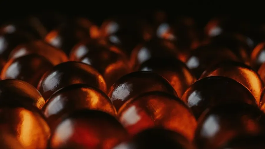 Illuminated amber spheres on a dark background