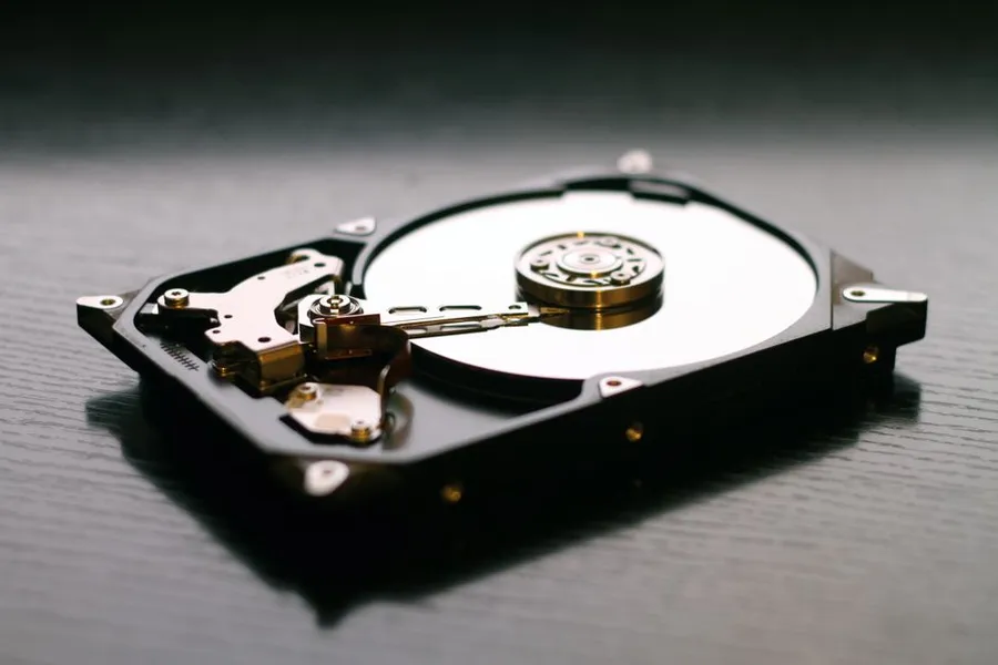 An opened hard drive on a dark surface