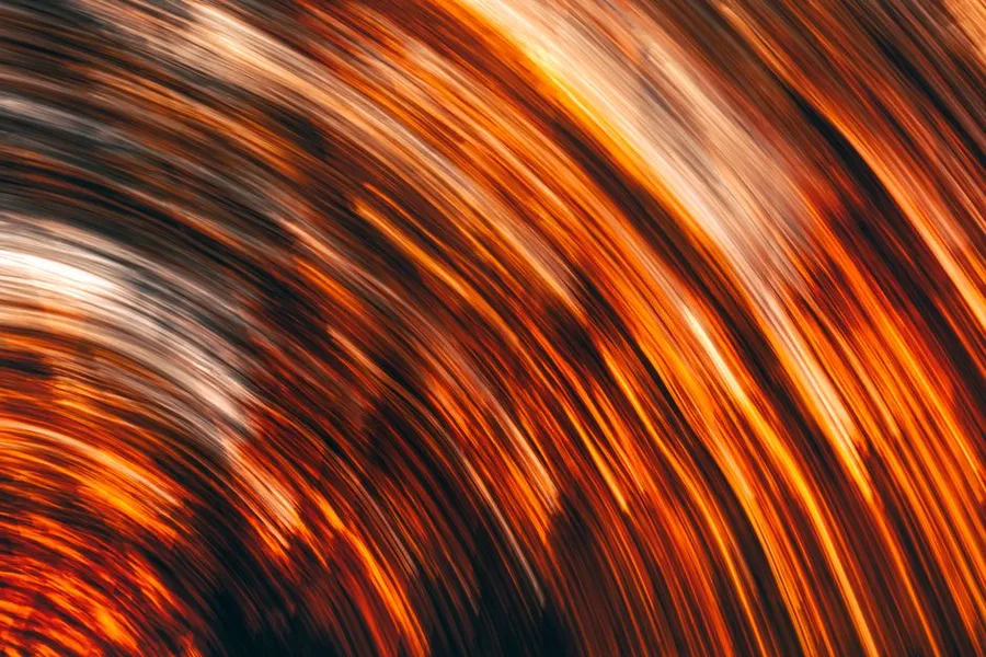Orange light streams in motion, like flowing data